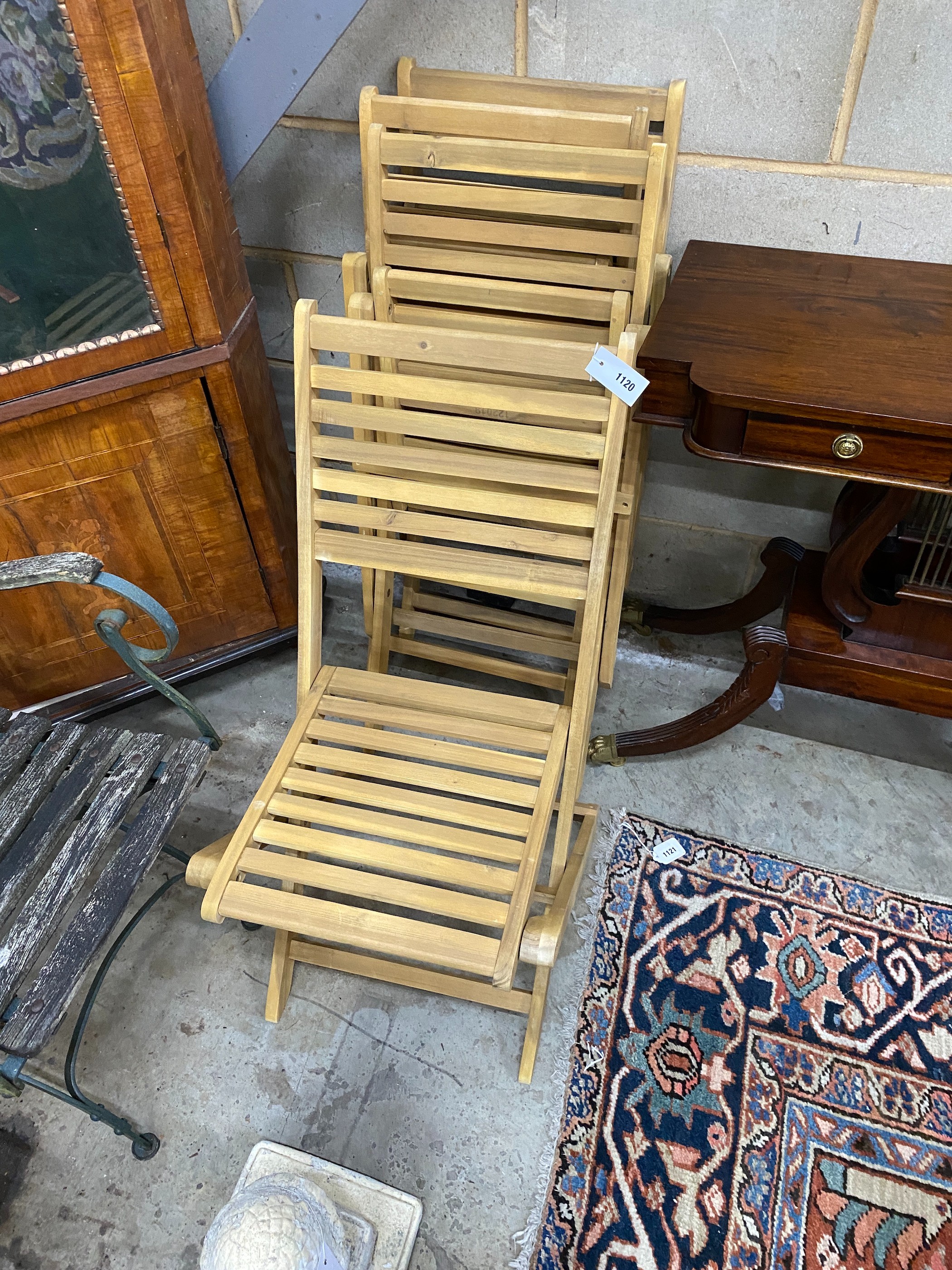 A set of four slatted wood folding garden chairs